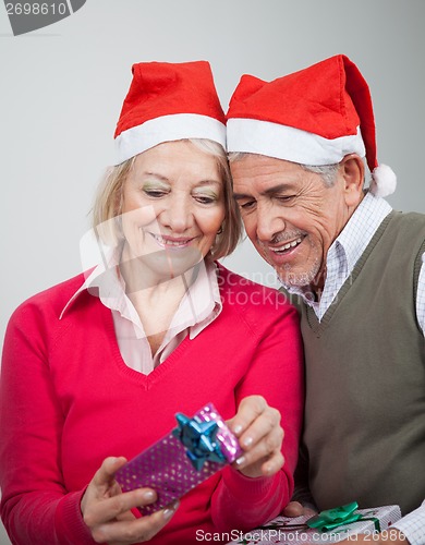 Image of Happy Senior Couple Looking At Christmas Gifts