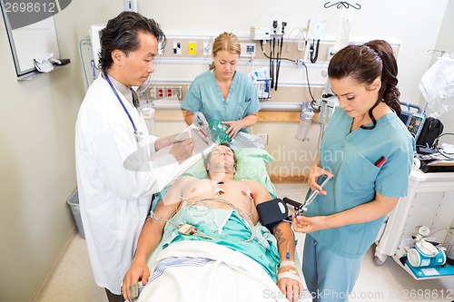 Image of Doctor And Nurses Treating Critical Patient