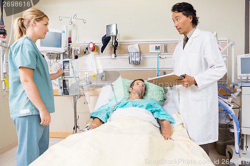 Image of Doctor Discussing Medical Report With Nurse