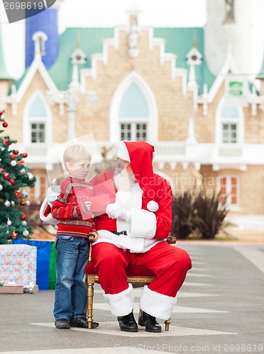 Image of Boy Giving Letter To Santa Claus