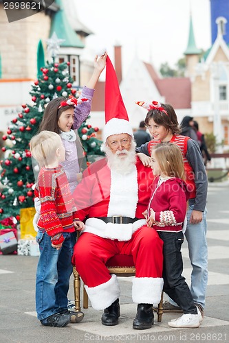 Image of Children Playing With Santa Claus's Hat
