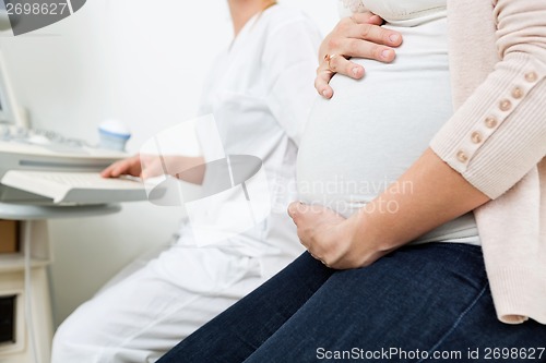 Image of Pregnant Woman With Gynecologist In Background