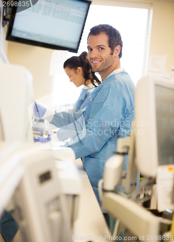 Image of Researcher With Colleague Working In Laboratory