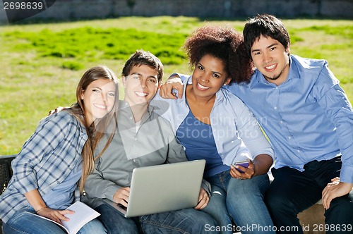 Image of Students With Laptop And Book Sitting In College Campus