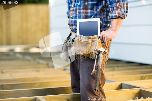 Image of Construction Worker With Tablet Computer And Hammer In Toolbelt