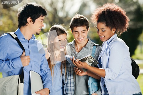 Image of Students Reading Book Together In Campus