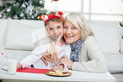 Image of Grandmother And Girl Smiling During Christmas