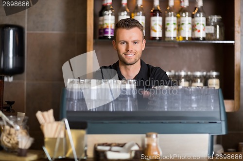 Image of Smart Male Bartender At Counter In Cafe