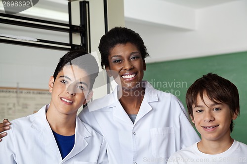 Image of Teacher And Schoolboys Standing Together In Science Lab