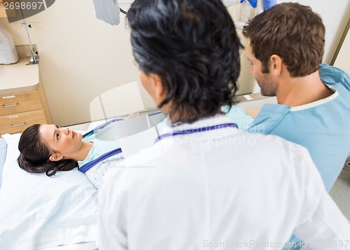 Image of Nurse And Doctor Preparing Patient For Xray