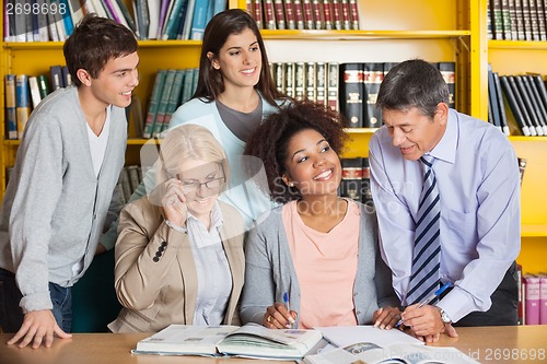 Image of Teachers Discussing With Students In Library