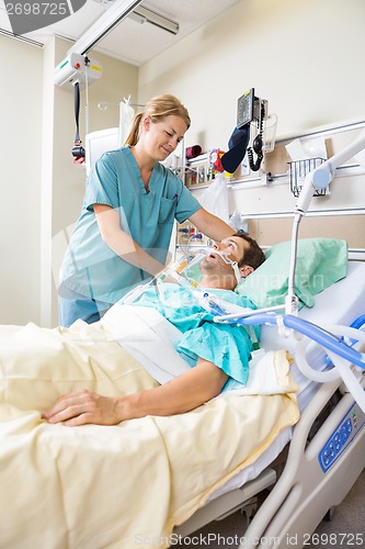 Image of Nurse Adjusting Patient's Pillow