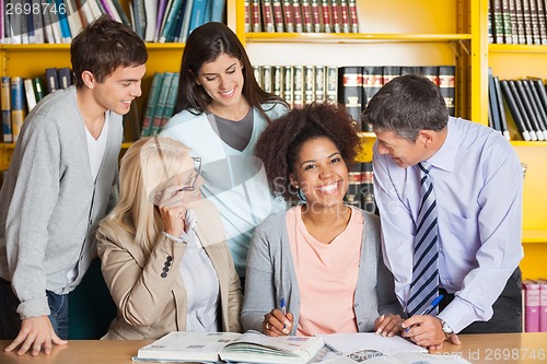 Image of Cheerful Student With Teachers And Classmates In Library