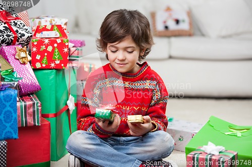 Image of Boy Looking At Christmas Presents