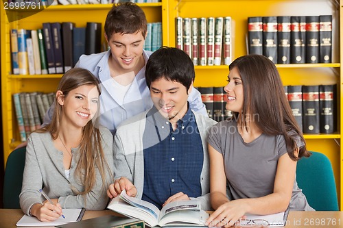 Image of Woman With Friends Studying In University Library