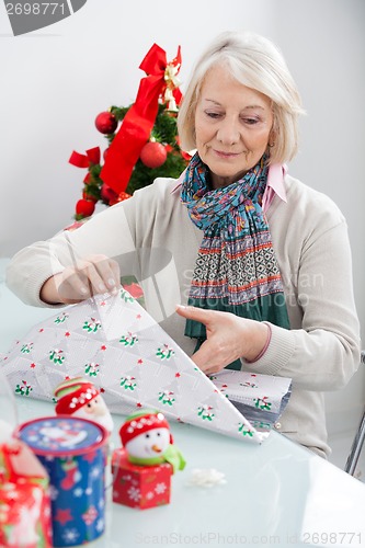 Image of Woman Wrapping Christmas Present