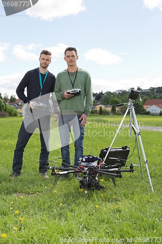 Image of Engineers Holding Remote Controls Of UAV