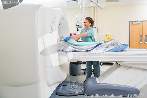 Image of Nurse Preparing Patient For CT Scan Test