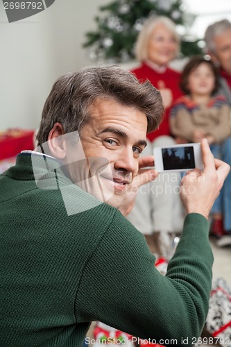 Image of Father Photographing Family Through Smartphone