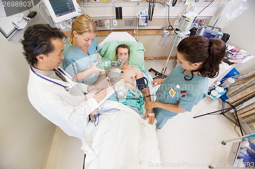Image of Doctor And Nurses Treating Critical Patient In Hospital