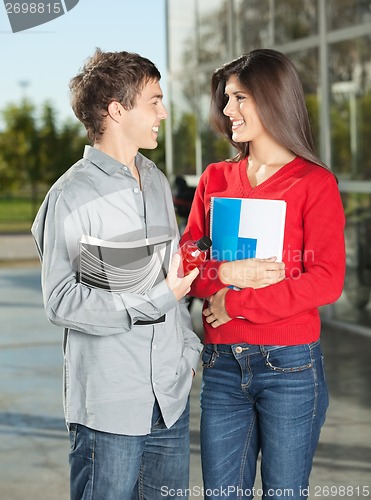 Image of Students With Books Looking At Each Other On Campus