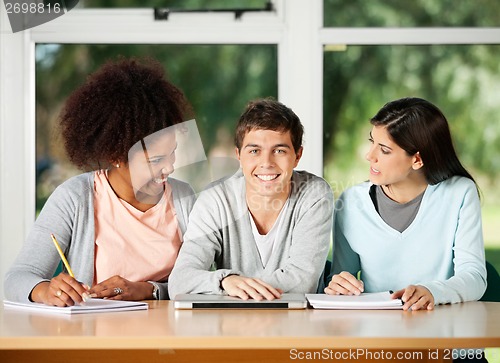 Image of Student With Classmates Looking At Each Other In Classroom