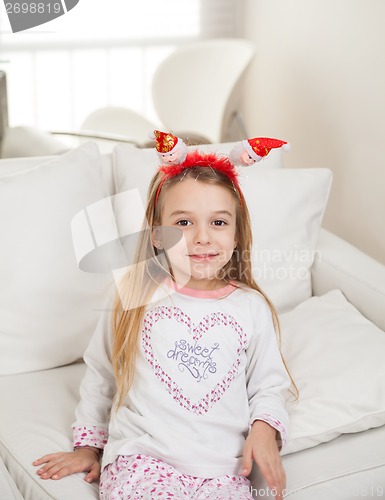 Image of Cute Girl Wearing Santa Headband At Home