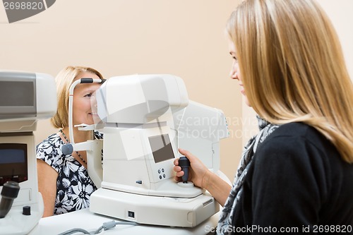 Image of Optometrist Using Tonometer to Measure Patients Eye Pressure