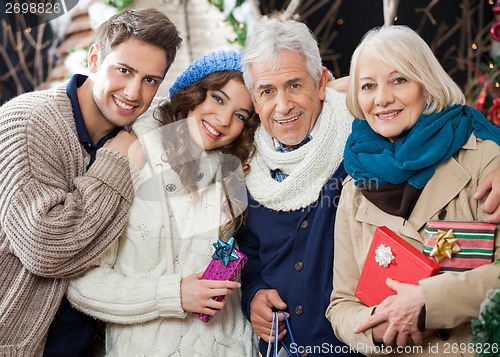 Image of Happy Loving Family Standing In Christmas Store