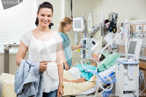 Image of Happy Woman With Nurse Examining Patient