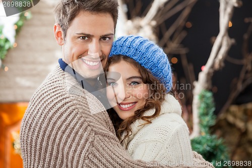 Image of Happy Couple Embracing In Christmas Store