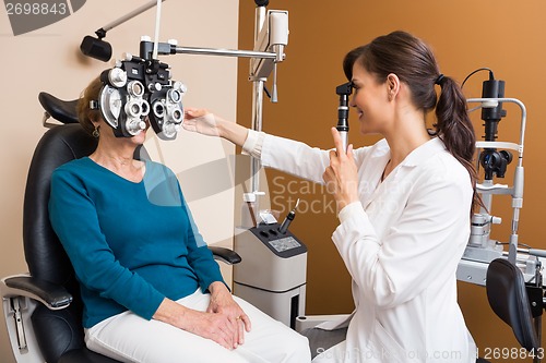 Image of Optometrist Examining Senior Woman's Eyes