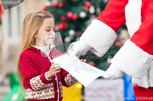 Image of Santa Claus Taking Letter From Girl