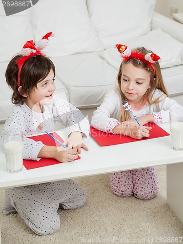 Image of Siblings Writing Letters To Santa Claus