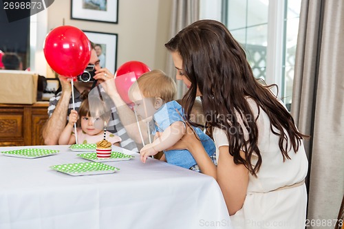 Image of Family Celebrating Son's Birthday At Home