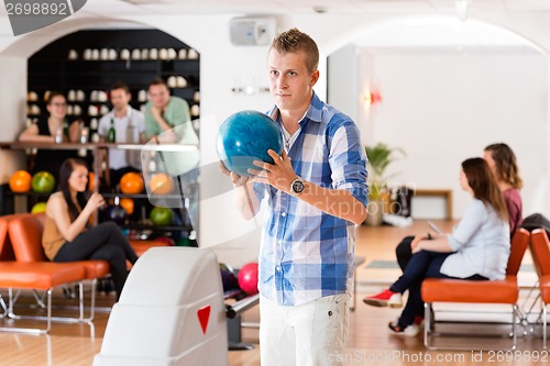 Image of Man Ready With Bowling Ball in Club