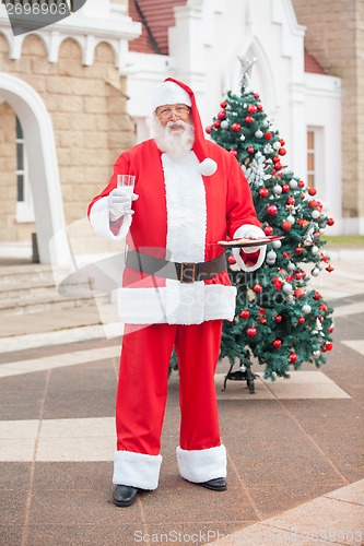 Image of Santa Claus With Milk And Cookies In Courtyard