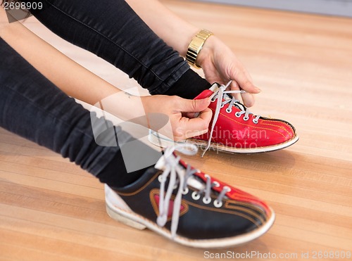 Image of Woman Tying Shoe Lace in Club