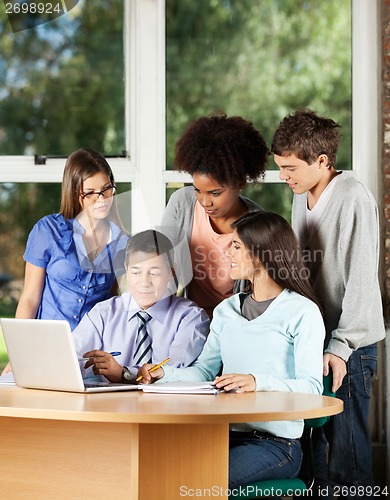 Image of Professor With Laptop Explaining Students In Classroom