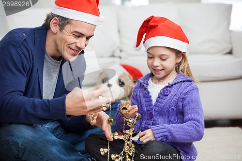 Image of Father And Daughter Looking At Christmas Decorations