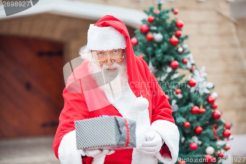 Image of Santa Claus Giving Christmas Present