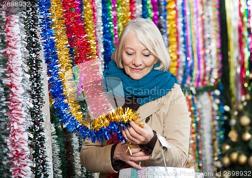 Image of Woman Shopping For Tinsels At Christmas Store