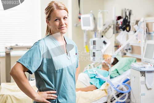 Image of Confident Nurse With Patient Resting In Background