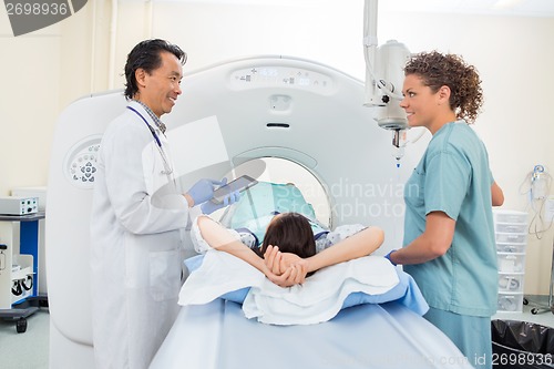 Image of Medical Team With Patient In CT Scan Room