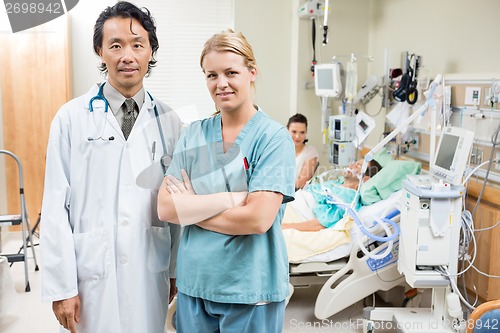 Image of Nurse And Doctor With Patient Resting In Background