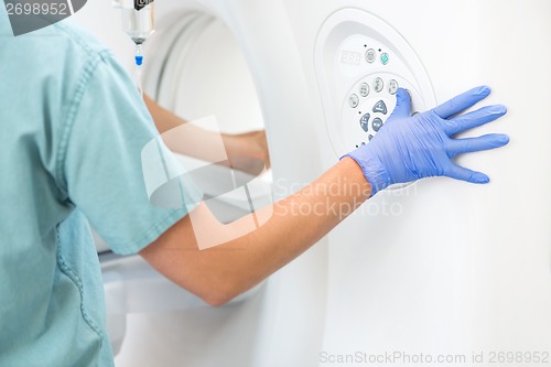 Image of Nurse Operating CT Scan Machine