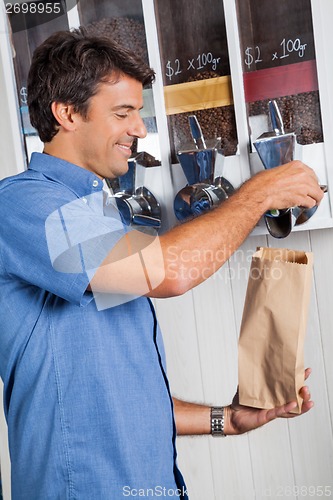 Image of Male Customer Buying Coffee Beans At Supermarket