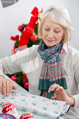 Image of Woman Wrapping Christmas Gift