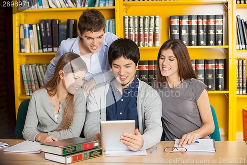 Image of Students With Digital Tablet Studying Together In College Librar