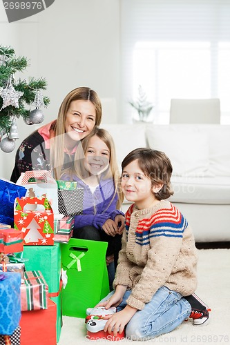 Image of Mother And Children With Christmas Gifts